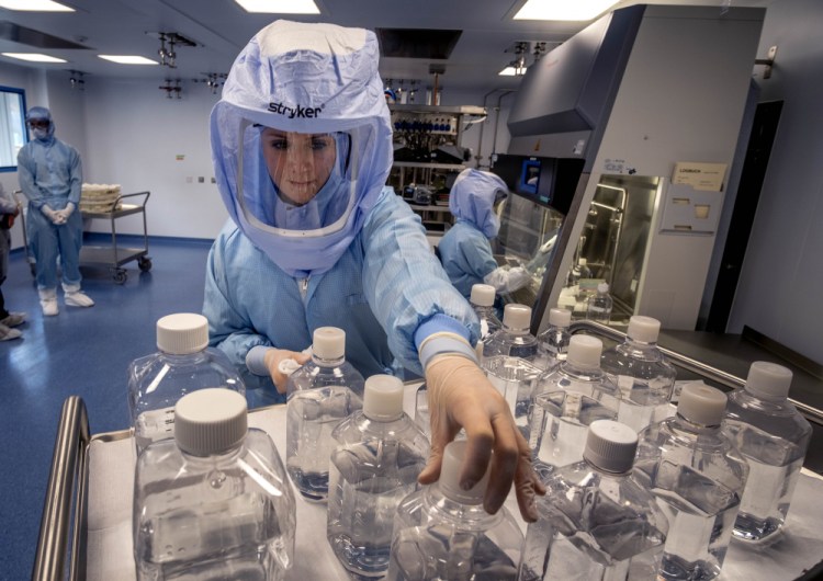 A laboratory worker simulates the workflow in a cleanroom of the BioNTech Corona vaccine production in Marburg, Germany, during a media day on March 27. 