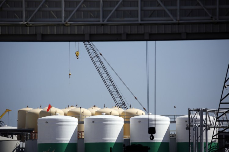 Storage tanks and cranes stand at an oil industry support facility in Port Fourchon, La., on June 11, 2020. MUST CREDIT: Bloomberg photo by Luke Sharrett.