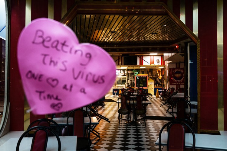 A heart emblazoned with a hopeful message appears at American Coney Island in Detroit. The popular tourist site is closed during Michigan's stay-at-home order during a coronavirus surge. MUST CREDIT: Photo by Nick Hagen for The Washington Post.