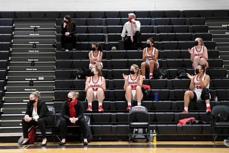 James Madison High School basketball players cheer from the bench during the second half against Osbourn Park on Feb. 20 in Vienna, Va. MUST CREDIT: Photo for The Washington Post by Will Newton