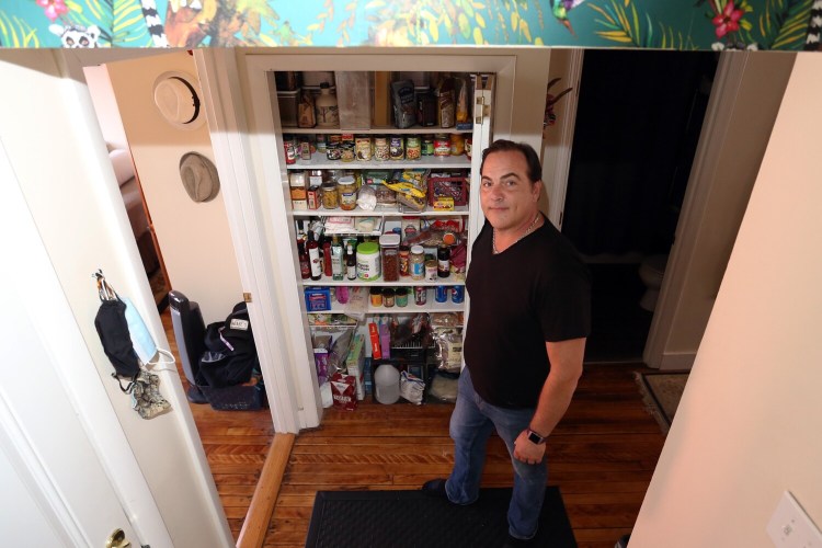 PORTLAND, ME - MAY 9: Eric Flynn, owner of Excellence Realty, has leftover pantry staples he squirreled away for the pandemic. He added new shelves in his hallway so he would have a place to store the food, and the shelves are still stocked. (Staff photo by Ben McCanna/Staff Photographer)