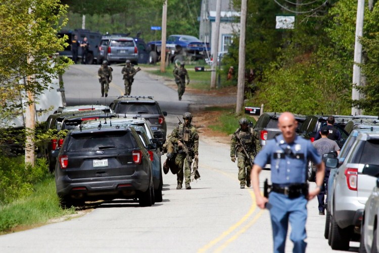 BUXTON, ME - MAY 18: Police depart after searching Brady Dix Sr.'s home, top center, in Buxton. Dix, who is at large, may be armed, according to police. (Staff photo by Ben McCanna/Staff Photographer)