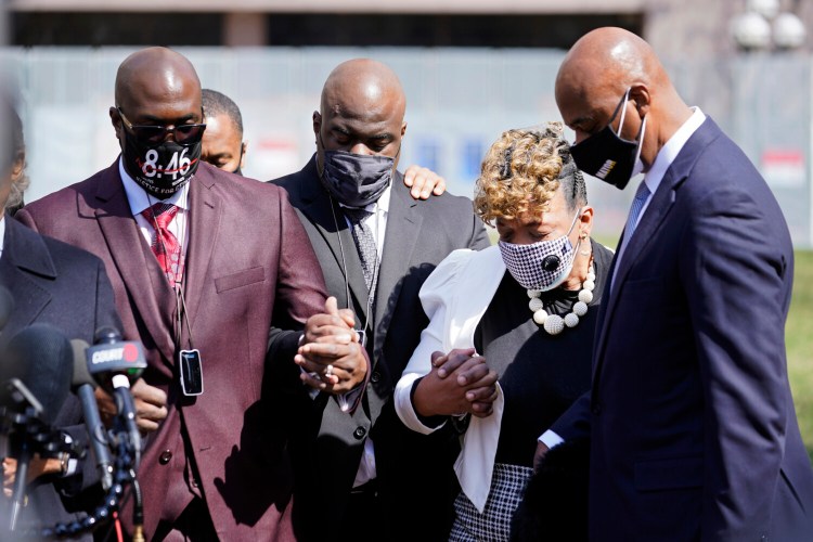 Philonise Floyd, left, the brother of George Floyd and other family members along with Gwen Carr, the mother of Eric Garner, take part in a prayer vigil led by the Rev. Al Sharpton outside the Hennepin County Government Center during lunch break Tuesday, April 6, 2021, in Minneapolis where testimony continues in the trial of former Minneapolis police officer Derek Chauvin. Chauvin is charged with murder in the death of George Floyd during an arrest last May in Minneapolis. (AP Photo/Jim Mone)