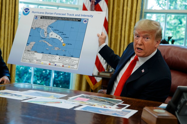 President Donald Trump talks with reporters after receiving a briefing on Hurricane Dorian on Sept. 4, 2019. A new 46-person federal scientific integrity task force with members from dozens of government agencies will meet for the first time Friday. The effort was spurred by concerns that the Trump administration had politicized science in ways that put lives at risk.