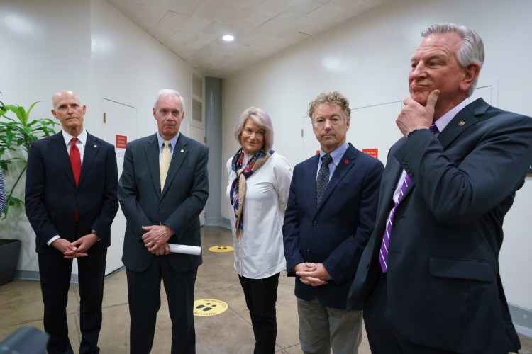 GOP senators, from left, Sen. Rick Scott, R-Fla., Sen. Ron Johnson, R-Wis., Sen. Cynthia Lummis, R-Wyo., Sen. Rand Paul, R-Ky., and Sen. Tommy Tuberville, R-Ala., talk to reporters as the Senate tries to finish to its work going into the Memorial Day recess, at the Capitol in Washington, Friday, May 28, 2021. Republican leaders are insisting they will block a commission on the Jan. 6 insurrection by a mob loyal to former President Donald Trump. (AP Photo/J. Scott Applewhite)