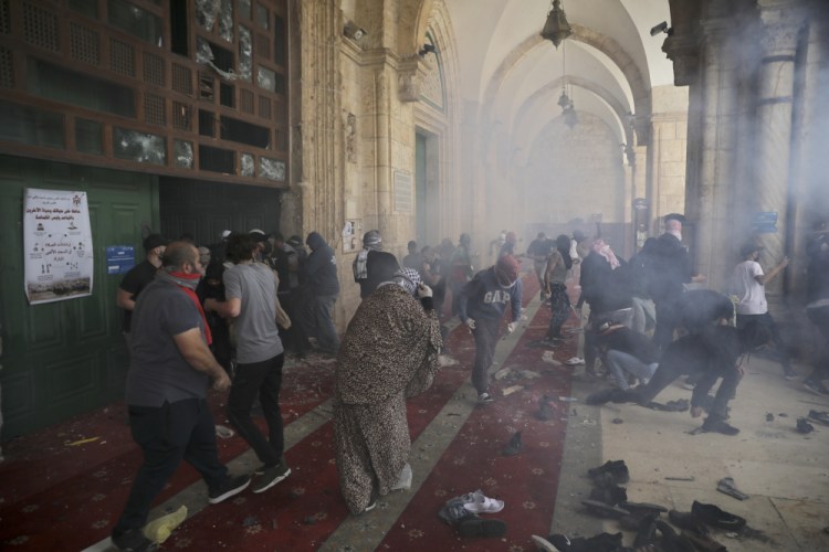 Palestinians clash with Israeli security forces at the Al Aqsa Mosque compound in Jerusalem's Old City Monday. Israeli police clashed with Palestinian protesters at a flashpoint Jerusalem holy site on Monday, the latest in a series of confrontations that is pushing the contested city to the brink of eruption. 