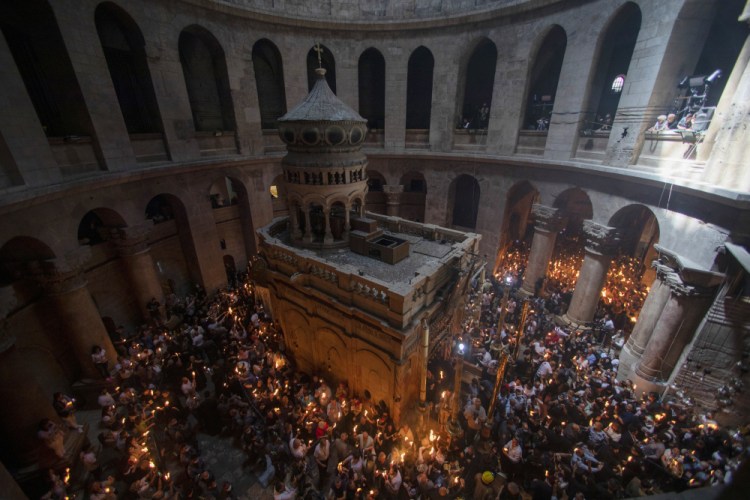 Christian pilgrims hold candles as they gather during the ceremony of the Holy Fire at The Church of the Holy Sepulchre, where many Christians believe Jesus was crucified, buried and rose from the dead, in the Old City of Jerusalem, on Saturday.

