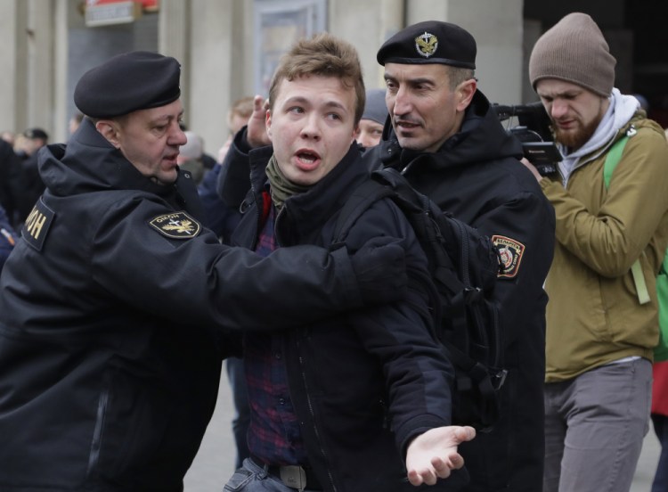 Belarus police detain journalist Raman Pratasevich, center, in Minsk, Belarus in March 2017. Pratasevich, a founder of a messaging app channel that has been a key information conduit for opponents of Belarus’ authoritarian president, has been arrested after an airliner in which he was riding was diverted to Belarus because of a bomb threat. The presidential press service said President Alexander Lukashenko personally ordered that a MiG-29 fighter jet accompany the Ryanair plane — traveling from Athens, Greece, to Vilnius, Lithuania — to the Minsk airport. ﻿﻿