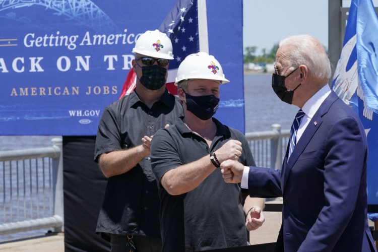 President Biden greets people as he arrives to speak Thursday in Lake Charles, La. 