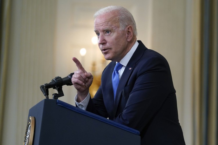 President Biden speaks to reporters at the White House on Wednesday. His administration is supporting efforts to waive intellectual property protections for COVID-19 vaccines in an effort to speed the end of the pandemic.