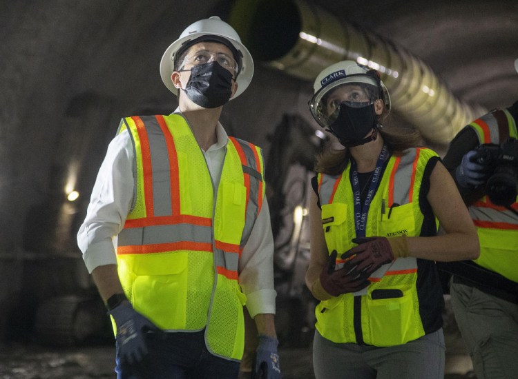 Construction project manager Gabrielle Ferro, second right, speaks with U.S. Secretary of Transportation Pete Buttigieg, during a tour of an underground tunnel for the expansion of the Hartsfield–Jackson Atlanta International Airport train tunnel May 21.

