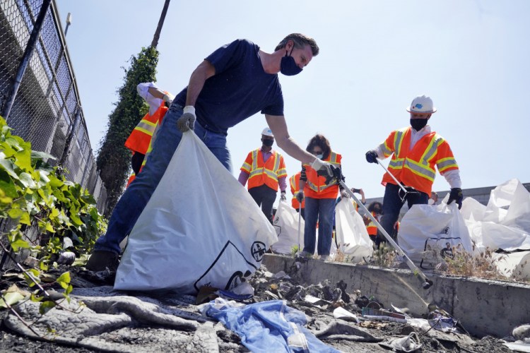California Gov. Gavin Newsom joins a cleanup effort May 11 in Los Angeles.