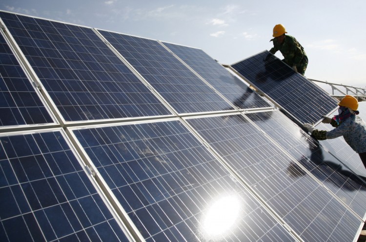 Workers install solar panels at a photovoltaic power station in Eastern Xinjiang, China. John Kerry, the U.S. climate enjoy, told legislators last week that the administration believes  solar panels "in some cases are being produced by forced labor.” 