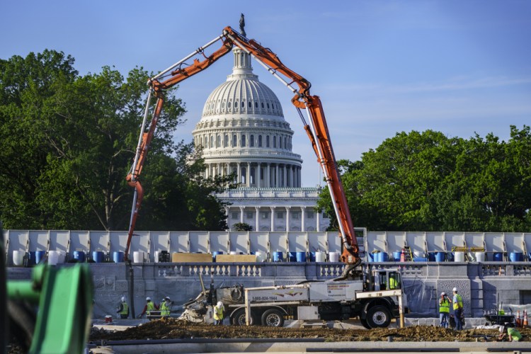 A concrete pump frames the Capitol Dome during renovations and repairs to Lower Senate Park on Capitol Hill in Washington in May.  