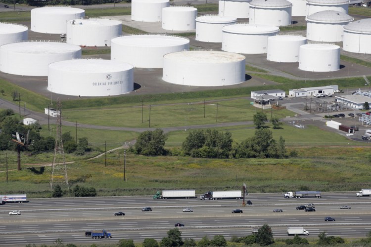 Traffic on I-95 passes oil storage tanks owned by the Colonial Pipeline Company in Linden, N.J., in 2008. Friday's incident was the worst cyberattack to date on critical U.S. infrastructure. 