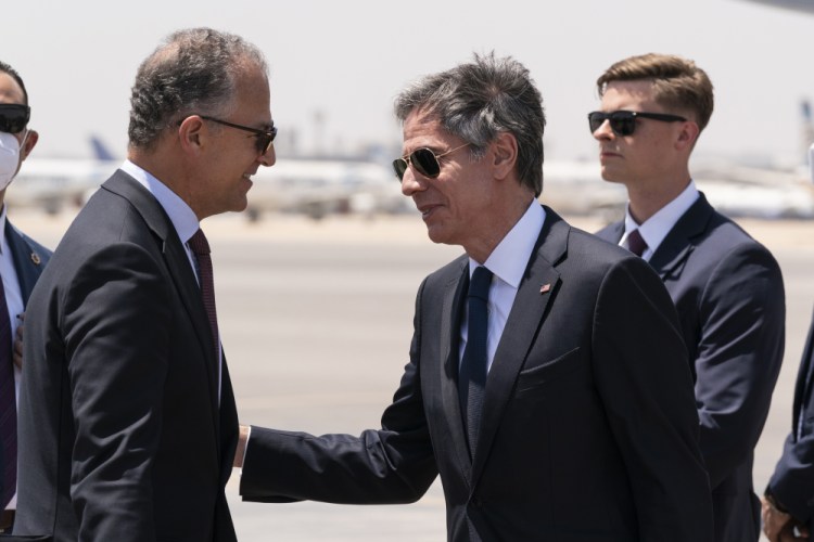 Secretary of State Antony Blinken, second from right, is greeted by U.S. Ambassador to Egypt Jonathan Cohen upon arrival at Cairo International Airport on Wednesday in Cairo, Egypt. 