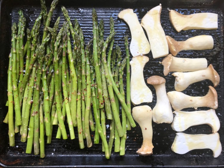 Roasting asparagus and trumpet mushrooms.