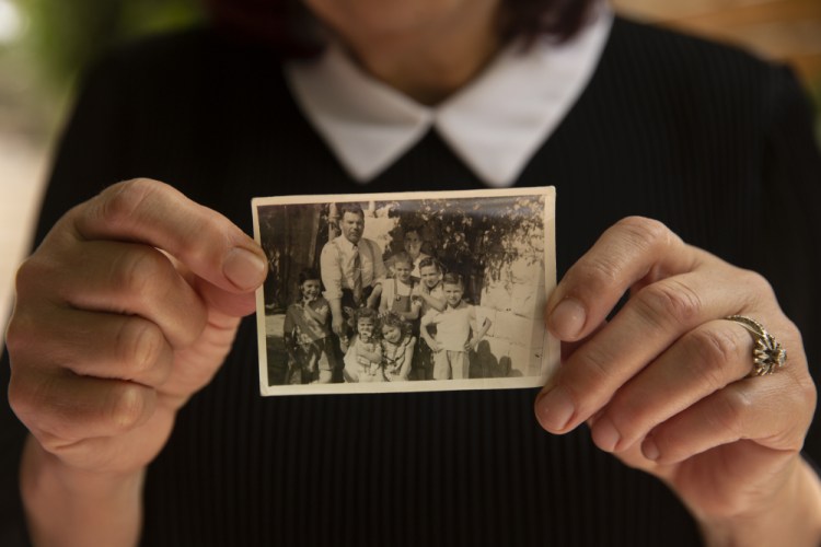 Samira Dajani holds a photo of her family in 1956 after they moved into their home in the Sheikh Jarrah neighborhood of east Jerusalem, Sunday. The Dajanis are one of several Palestinian families facing imminent eviction in the Sheikh Jarrah neighborhood of east Jerusalem.