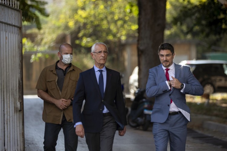 Members of Carlos Ghosn's defense team, lawyer Jean Yves Le Borgne, center, and Jean Tamalet, right, leave the Justice Palace in Beirut, Lebanon, on Monday.

