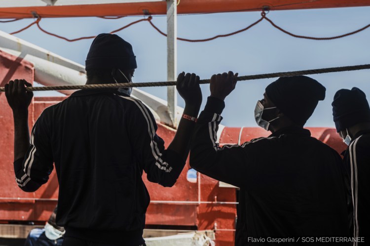 Migrants look at the sea from aboard the Ocean Viking during its navigation in the Mediterranean Sea on Thursday. 

