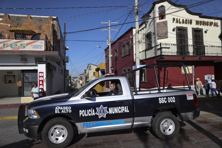A police officer drives past town hall in Apaseo El Alto, Guanajuato state, Mexico, in 2020. The notoriously violent Jalisco cartel has responded to Mexico's “hugs, not bullets” policy with a policy of their own: The cartel kidnapped in mid-May 2021, several members of an elite police force in the state of Guanajuato, tortured them to obtain names and addresses of fellow officers, and are now hunting down and killing police at their homes, on their days off, in front of their families. 

