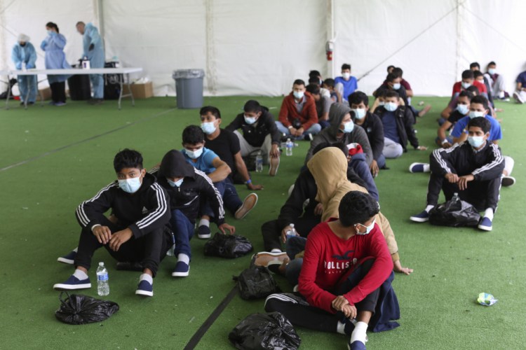Young migrants wait to be tested for COVID-19 at the Donna Department of Homeland Security holding facility, the main detention center for unaccompanied children in the Rio Grande Valley, in Donna, Texas, on March 30. 