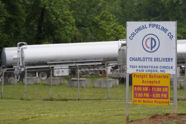Tanker trucks are parked near the entrance of Colonial Pipeline Company on May 12 in Charlotte, N.C. The FBI linked the ransomware to a Russian-speaking criminal syndicate known as DarkSide.
