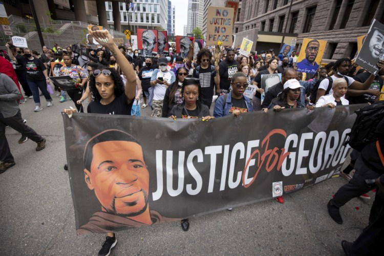 People march for the one year anniversary of George Floyd's death on Sunday in Minneapolis, Minn. 