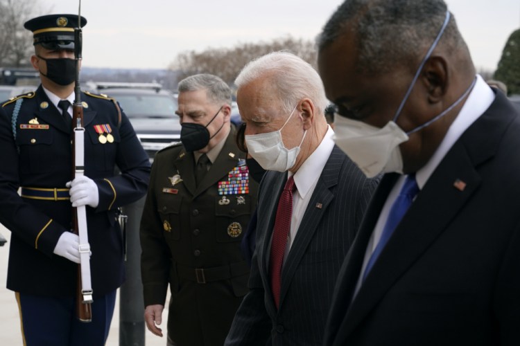 President Biden walks with Joint Chiefs Chairman Gen. Mark Milley, second from left, and Defense Secretary Lloyd Austin as he arrives at the Pentagon in February. Milley said he has shifted his thinking on policy changes regarding sexual assault in the military in part because he is concerned by indications of a lack of confidence by junior enlisted service members in the fairness of sexual assault case outcomes. 