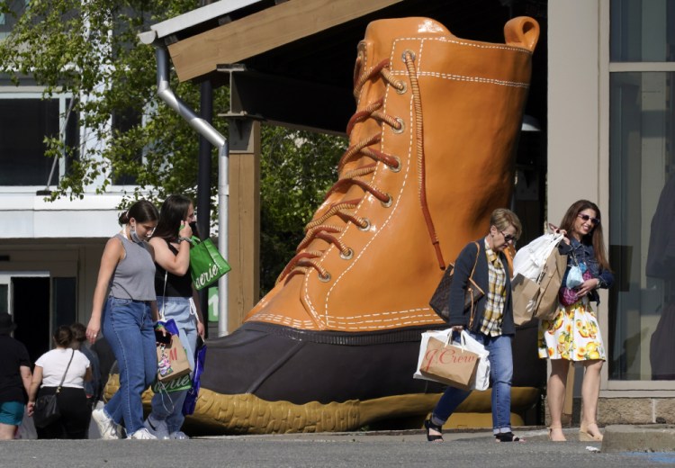 Shoppers walk past a giant L.L. Bean boot outside the Ross Park Mall in Pittsburgh on Sunday.