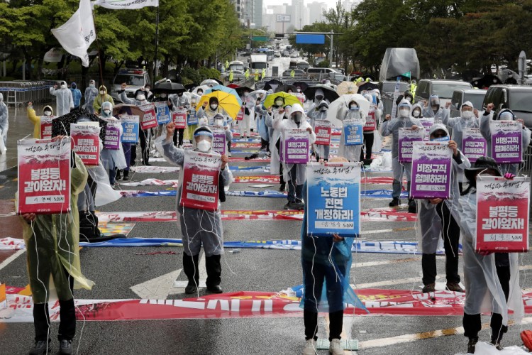 Members of the Korean Confederation of Trade Unions stage a May Day rally Saturday demanding better working conditions and expanding labor rights in Seoul, South Korea. The signs read: "Let's solve inequality."