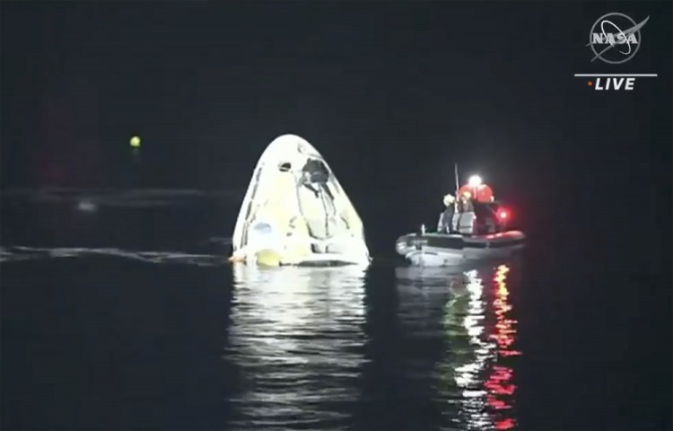 The SpaceX Dragon capsule floats after landing in the Gulf of Mexico near the Florida Panhandle early Sunday. SpaceX returned four astronauts from the International Space Station on Sunday, making the first U.S. crew splashdown in darkness since the Apollo 8 moonshot.