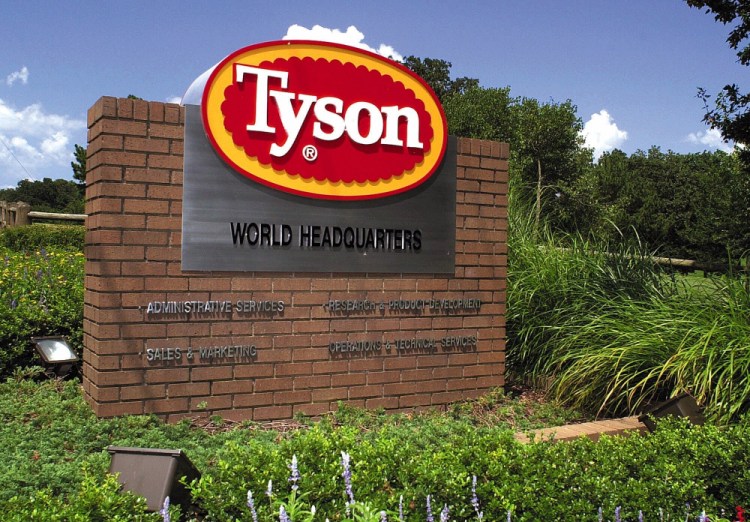 A sign marks the entrance to Tyson Foods headquarters in Springdale, Ark., in 2001. The company said Monday that absentee rates are around 50 percent higher than they were before the pandemic. 