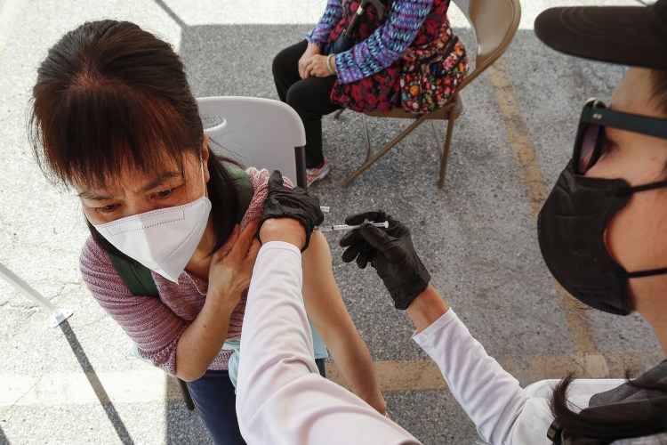 A woman receives a COVID-19 vaccination at a mobile clinic in Los Angeles' Chinatown. (Al Seib/Los Angeles Times/TNS)