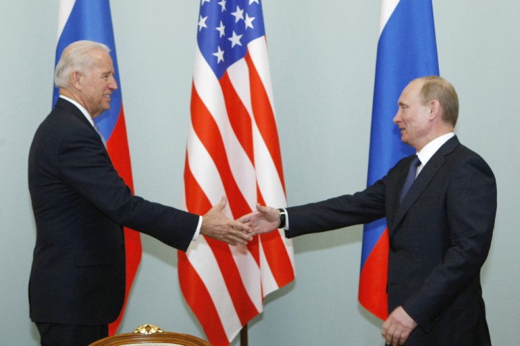 Then-Vice President Joe Biden, left, shakes hands with Russian Prime Minister Vladimir Putin in Moscow, Russia on March 10, 2011. Biden will hold a summit with Vladimir Putin next month in Geneva.