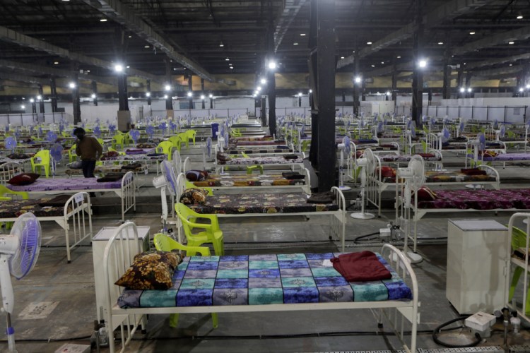 Newly arranged beds lie inside a COVID-19 treatment center set up for emergencies in the wake of spike in the numbers of positive coronavirus cases in Mumbai, India, Thursday, May 6. Infections in India hit another grim daily record on Thursday as demand for medical oxygen jumped seven-fold and the government denied reports that it was slow in distributing life-saving supplies from abroad. 