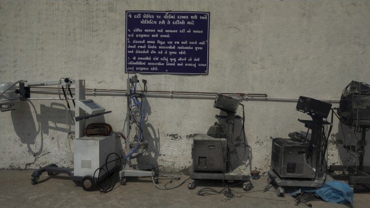 Instructions for COVID-19 patients are seen on a signage in Gujarati next to damaged equipment after a deadly fire at the Welfare Hospital in Bharuch, western India, on Saturday.

