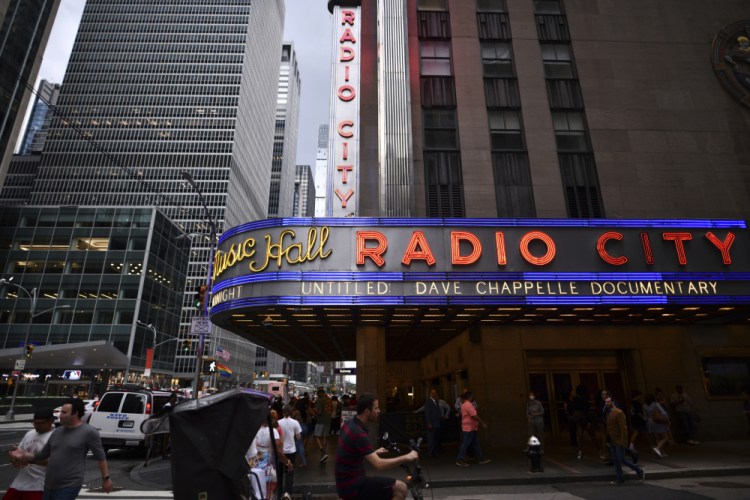 Radio City Music Hall's marquee advertises Dave Chappelle's documentary for the 20th Tribeca Festival on Saturday. “Dave Chappelle: This Time This Place,” chronicles his pandemic stand-up series held in Ohio cornfields.