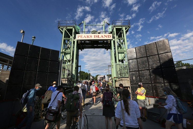 PORTLAND, ME - JUNE 9: Passengers depart the Machigonne II at Peaks Island on Wednesday evening. Casco Bay Lines is creating a priority boarding pass program for Peaks Island residents. (Staff photo by Ben McCanna/Staff Photographer)