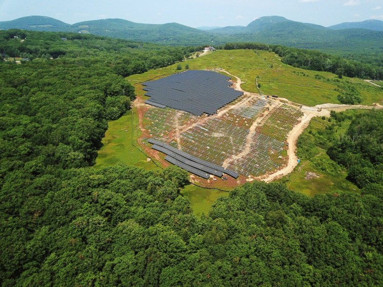 Roughly 12 acres of wild blueberry fields in Rockport are being covered with more than 10,000 solar panels, a first-in-Maine experiment in dual-use design to pair solar energy with agriculture. Special construction and design techniques are being used to maximize power production while minimizing impact on the crop. Developers and agriculture officials hope the lessons learned can be applied to other blueberry farms. (Photo courtesy of BlueWave Solar)