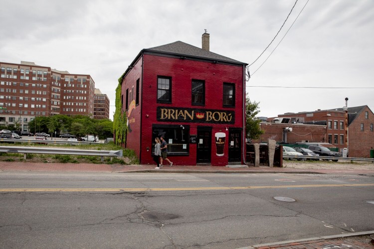 PORTLAND, ME - JUNE 11: Pedestrians walk past the old Brian Boru building on Center Street in Portland on Friday, June 11, 2021. (Staff photo by Brianna Soukup/Staff Photographer)