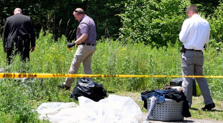Maine State Police evidence technicians follow a blood trail from a residence in Somerville on June 30, 2021, where a man died following an altercation. State prosecutors have announced they will not bring charges in the case. 
