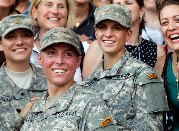 Army 1st Lt. Shaye Haver, center, and Capt. Kristen Griest, right, pose for photos with other female West Point alumni after an Army Ranger school graduation ceremony at Fort Benning, Ga., on Aug. 21, 2015. The director of the American Civil Liberties Union’s Women’s Rights Project is urging the Supreme Court to take up whether it's unconstitutional to require men but not women to register for the draft when they turn 18.