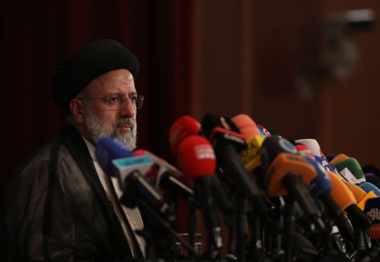 Iran's President-elect Ebrahim Raisi at a press conference in Tehran on Monday. He promised to salvage the nuclear accord to secure relief from U.S. sanctions. 