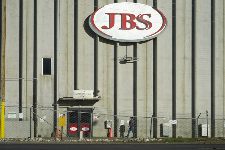 A worker goes into the JBS meatpacking plant in Greeley, Colo., on Oct. 12. 

