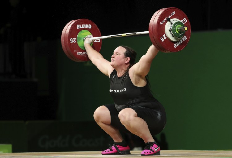 FILE - In this April 9, 2018 file photo, New Zealand's Laurel Hubbard lifts in the snatch of the women's +90kg weightlifting final at the 2018 Commonwealth Games on the Gold Coast, Australia. Hubbard will be the first transgender athlete to compete at the Olympics. 