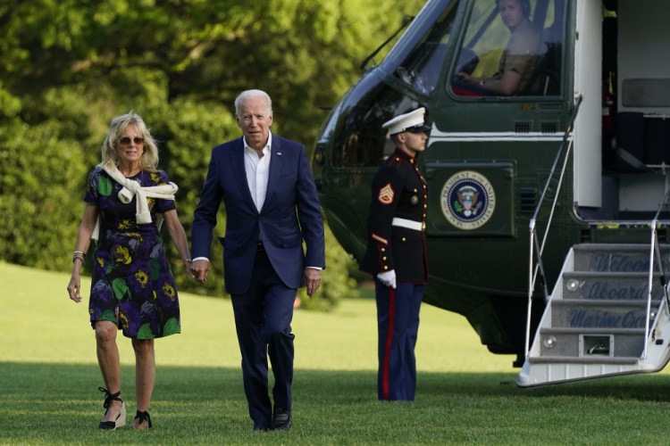 President Biden and first lady Jill Biden arrive at the White House on Sunday. 