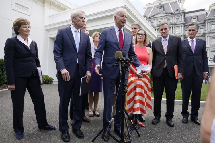President Biden, with a bipartisan group of senators, speaks Thursday outside the White House in Washington. Biden invited members of the group of 21 Republican and Democratic senators to discuss the infrastructure plan. 

