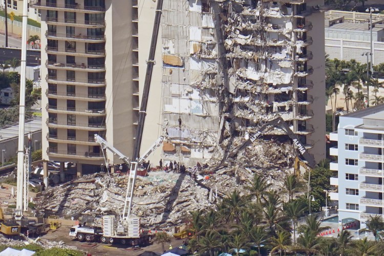 Crews work in the rubble at the Champlain Towers South Condo on Sunday in Surfside, Fla. One hundred fifty-nine people were still unaccounted for two days after Thursday's collapse.