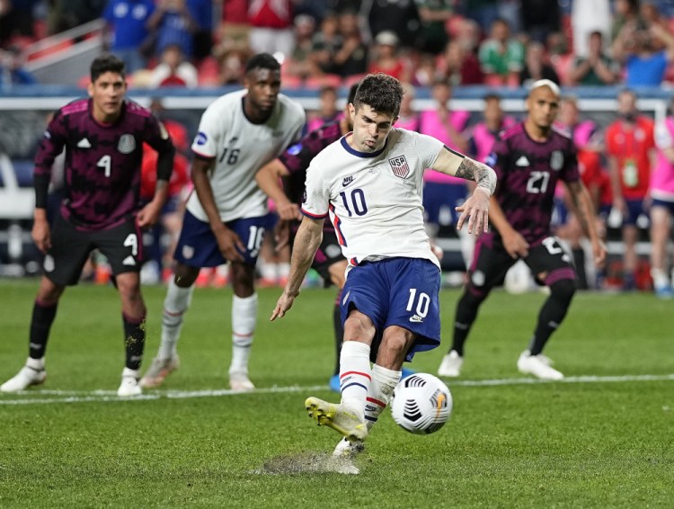 Christian Pulisic scores on a penalty kick against Mexico during extra time in the CONCACAF Nations League championship soccer match late Sunday night.